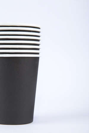 Close up front view of recycled black paper glasses on end, isolated on white background.の写真素材