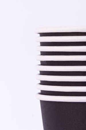 Close up front view of recycled black paper glasses on end, isolated on white background.の写真素材