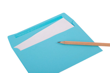 Close up top view of a pencil lying on empty envelope, isolated on white background.