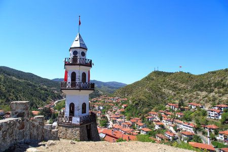 Front view of wooden tower building with three balcony in clear sky.