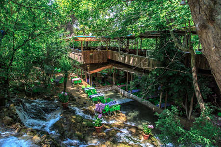 HATAY, TURKEY - JUNE 7, 2015 : Top view of restaurant with colourful table and chairs, settled in Harbiye Waterfall in Antakya.のeditorial素材