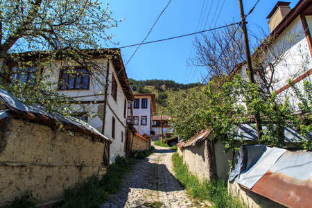 Front view of old cubblestone roads in a small town with historical old houses.の写真素材