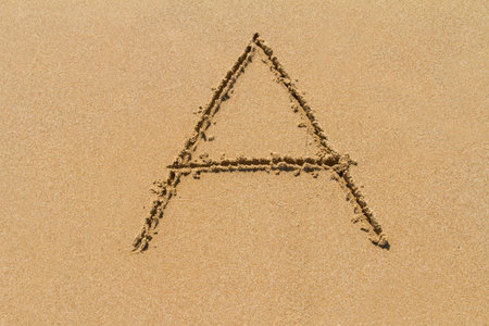 Letter A of the alphabet written on sand with upper case.