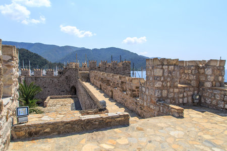 MUGLA, TURKEY - JUNE 1, 2015 : Inside view of high stone walls of historical old Marmaris Tower, on blue sky background.のeditorial素材