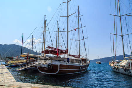 MUGLA, TURKEY - JUNE 1, 2015 : Sailing ships anchored on harbor of Marmaris marina, on blue sky background.のeditorial素材