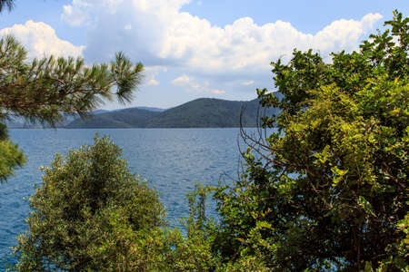 Seascape of Gokova, view of blue sea, forest and mountains ahead, on cloudy sky background.の写真素材