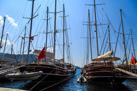 MUGLA, TURKEY - JUNE 1, 2015 : Sailboats anchored on harbor, ships in Marmaris Marina, on blue sky background.のeditorial素材