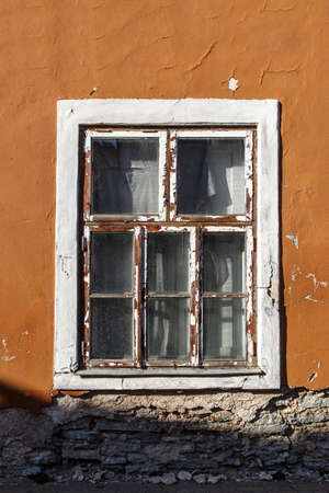 Close up view of brown wooden window of the old orange building.の写真素材