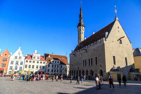 TALLINN, ESTONIA - APRIL 25, 2015 : Tourists and locals hanging around square and streets of Tallinn Old Town, on blue sky background.のeditorial素材