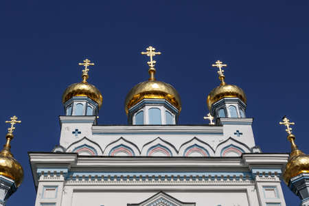 Close up bottom view of Orthodox Ss Boris and Gleb Cathedral in Dougavpils, Latvia, on navy blue sky background.の写真素材