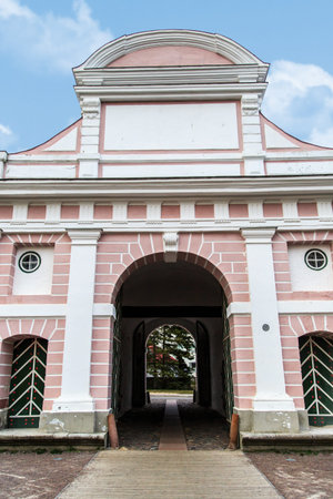 Front view of historical Tallinn Gate survivingfrom the 17th century in Parnu Estonia, on cloudy blue sky background.の写真素材