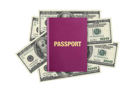 Close up front view of a passport, on one hundred dollar banknotes, isolated on white background.