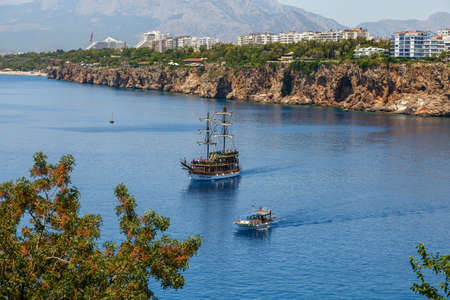 ANTALYA, TURKEY - JULY 20, 2015 : View of sailing boat in blue sea of Antalya, with high mountains around, on blue bright sky background.のeditorial素材