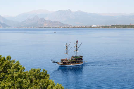 ANTALYA, TURKEY - JULY 20, 2015 : View of sailing boat in blue sea of Antalya, with high mountains around, on blue bright sky background.のeditorial素材