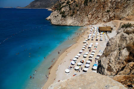 ANTALYA, TURKEY - JULY 19, 2015 : Top view of famous canyon junction beach of Antalya, Kaputas Beach with its turquoise water color, view of people swimming and sunbathing on bright blue sky background.のeditorial素材