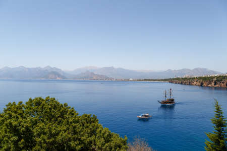 ANTALYA, TURKEY - JULY 20, 2015 : View of sailing boat in blue sea of Antalya, with high mountains around, on blue bright sky background.のeditorial素材