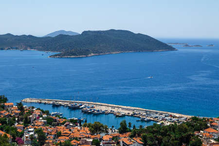 KAS, ANTALYA - JULY 19, 2015 : Seascape of Kas Marina with yachts and boats, touristic small town of Antalya, surrounded with high mountains with trees.のeditorial素材