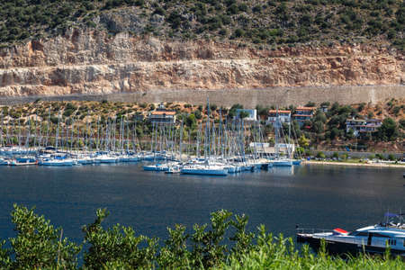 KAS, ANTALYA - JULY 19, 2015 : Seascape of Kas Marina with yachts and boats, touristic small town of Antalya, surrounded with high mountains with trees.のeditorial素材