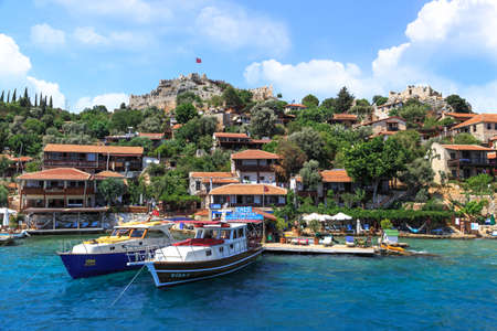 DEMRE, ANTALYA - JULY 18, 2015 : Seascape of Kekova Ancient Lycian City in Antalya, with sailing boats and yachts around, on bright blue sky background.のeditorial素材