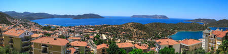 KAS, ANTALYA - JULY 19, 2015 : Panoramic seascape of Kas, touristic small town of Antalya, surrounded with high mountains with trees.のeditorial素材