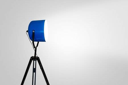 Close up side view of spotlight lighting with bright white bulb, on white background.の写真素材
