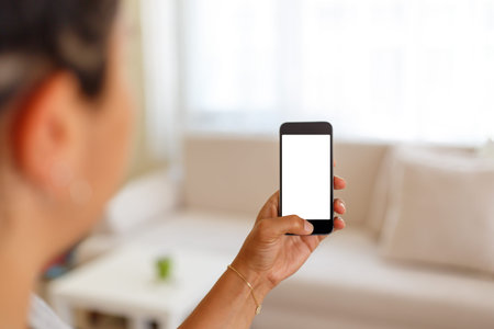 Close up detailed view of a smart phone holding on hand, pushing the button, with white blank copy...