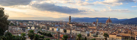 Top view of Florence city with arno river bridges and historical buildings, on cloudy sunrise or sunset sky background.のeditorial素材