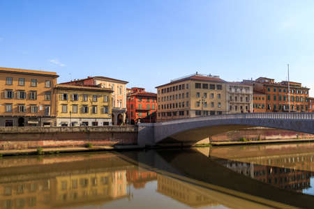 PISA, ITALY - SEPTEMBER 21, 2015 : View of historical buildings along the river in Pisa, Italy on bright blue sky background.のeditorial素材