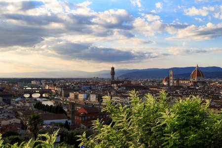 Top view of Florence city with arno river bridges and historical buildings, on cloudy sunrise or sunset sky background.のeditorial素材