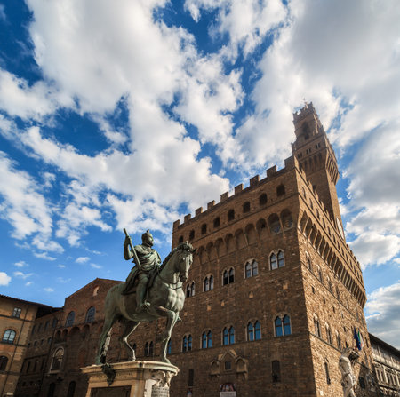 View of historical Vecchio Palace in Piazza Della Signoria in Florence, on cloudy blue sky background.のeditorial素材