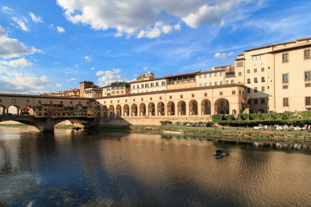 FLORENCE, ITALY - SEPTEMBER 22, 2015 : View of Vecchio Bridge on Arno river, with old buildings...