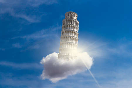 View of historical Pisa Tower flying on a cloud, in Cathedral Square of Pisa, Italy, on bright blue sky background.の写真素材