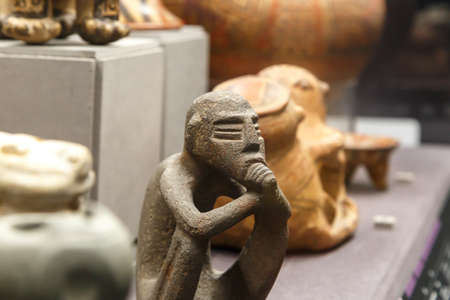 FLORENCE, ITALY - SEPTEMBER 20, 2015 : Close up detailed view of small basaltic olmec figurine exhibited in Florence Archeology Museum.のeditorial素材