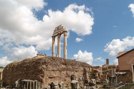 View of archeological area of ancient Roman Forum in Rome, on cloudy blue sky background.の写真素材