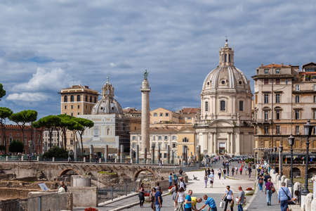 ROME, ITALY - SEPTEMBER 26, 2016 : View of an ancient Roman Forum with columns and ruins around in Rome, with tourists around, on cloudy sky background.のeditorial素材