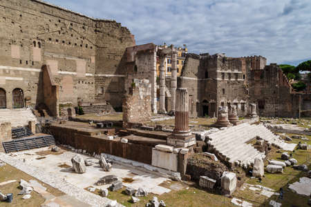 ROME, ITALY - SEPTEMBER 26, 2016 : View of an ancient Roman Forum with columns and ruins around in Rome, with tourists around, on cloudy sky background.のeditorial素材