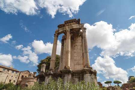 View of archeological area of ancient Roman Forum in Rome, on cloudy blue sky background.の写真素材