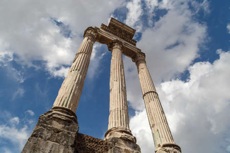 View of archeological area of ancient Roman Forum in Rome, on cloudy blue sky background.の写真素材