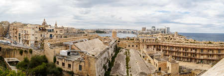 VALLETTA, MALTA - OCTOBER 30, 2015 : View of Valletta with historical limestone buildings, on cloudy sky background.のeditorial素材