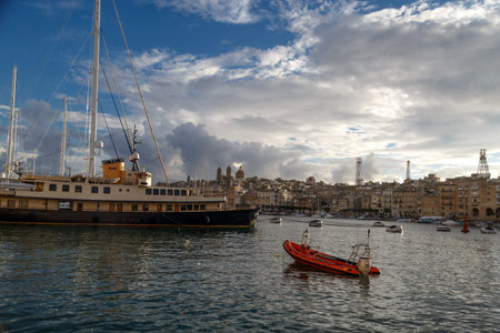 VALLETTA, MALTA - NPVEMBER 2, 2015 : View of Valletta marina with sailing boats, yatches and ships around, on cloudy sky background.のeditorial素材