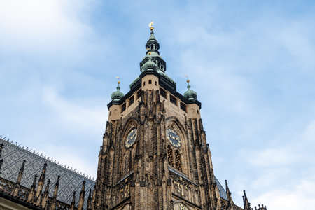 Bottom view of historical gothic St. Vitus Cathedral in old town of Prague, found in 1344, on cloudy blue sky background.の写真素材