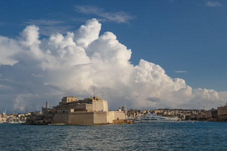 VALETTA, MALTA - NOVEMBER 2, 2015 : View of Valletta with ships and boats on coastline, on cloudy...