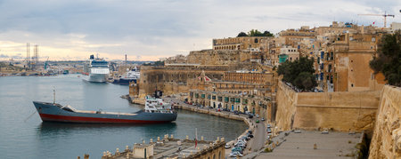 VALLETTA, MALTA - OCTOBER 30, 2015 : View of Valletta with ships and boats on coastline, on cloudy...