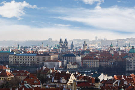 General top view of Prague cityscape view with historical gothic buildings around, on cloudy sky background.の写真素材