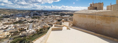 View of Cittadella, historical fortified small city of Cittadella with limestone structures, on cloudy blue sky background.の写真素材
