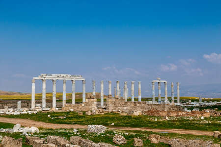 View of historical ancient city of Laodicea in Denizli with high columns on bright blue sky background.の写真素材