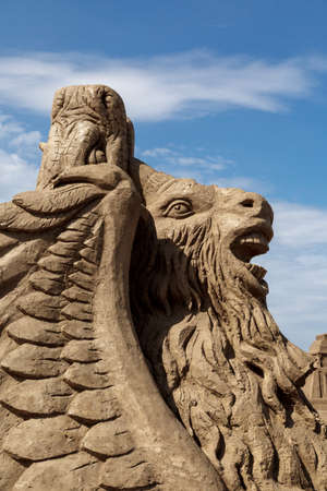 ANTALYA, TURKEY - APRIL 23, 2016 : View of big sand sculpture of mythological characters made in Lara Beach, Antalya for sandland project, on cloudy blue sky background.のeditorial素材