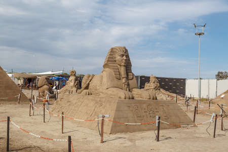 ANTALYA, TURKEY - APRIL 23, 2016 : View of big sand sculpture of mythological characters made in Lara Beach, Antalya for sandland project, on cloudy blue sky background.のeditorial素材