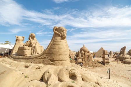 ANTALYA, TURKEY - APRIL 23, 2016 : View of big sand sculpture of mythological characters made in Lara Beach, Antalya for sandland project, on cloudy blue sky background.のeditorial素材