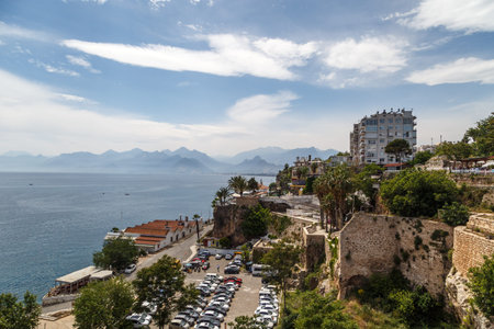 ANTALYA, TURKEY - APRIL 23, 2016 : Landscape view of touristic Antalya city with small buildings and trees around, on cloudy blue sky background.のeditorial素材